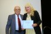 Dr. Nagib Callaos, General Chair, giving Dr. Marta Szabo White the best paper award certificate of the session "Society, Cybernetics and Informatics II". The title of the awarded paper is "Cultural Lens: A Critical Variable in the Microfoundations of Strategic Problem Formulation."